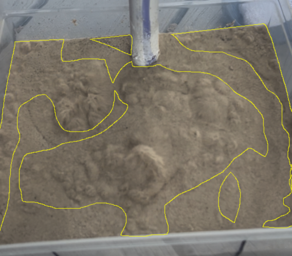 Effect of sub-layer water saturation on two-layer sand fluidization